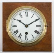 A circular brass bulkhead clock:,