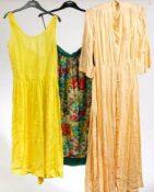 A collection of late 20th century skirts and textiles including a yellow cotton dress by French