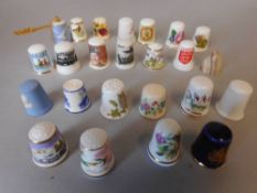 A collection of porcelain sewing thimbles: including jasperware examples, commemorative thimbles,