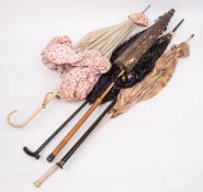 A group of five early 20th century parasols including a Chinese style paper parasol,