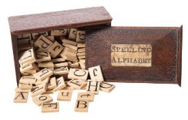 An early 19th century bone 'Spelling Alphabet' in mahogany box: comprising eighty two tiles with