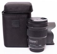 A Sigma 50mm f1.4 DG Art Series lens in original box and bag.