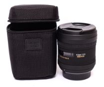 A Sigma 4.5mm f2.8 EX DC circular fish eye lens in original box and bag.