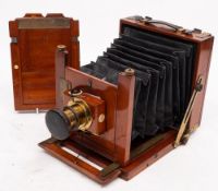 A Thornton Pickard mahogany and brass camera: fitted f8-64 brass lens,