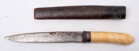 A Burmese dha dagger: the short blade over a white metal hilt and one piece ivory grip,