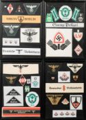 A framed collection of reproduction German arm bands and cloth badges.