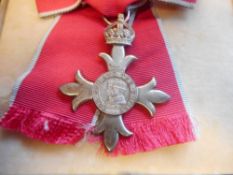 An M.B.E. (civil) : contained in a Royal Mint presentation case.