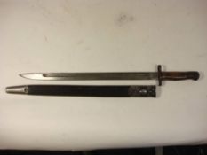 A 1907 pattern bayonet by Sanderson: the blade stamped and dated '3-16' over two piece wooden grip,