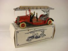A tinplate clockwork fire engine,: with silver turntable and ladder, red lithograph printed cab,
