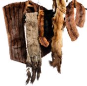 A collection of various fur stoles and collars.