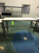 S/S TABLE ON CASTERS WITH PLASTIC CUTTING BOARD TOP APPX L60'' X W20''