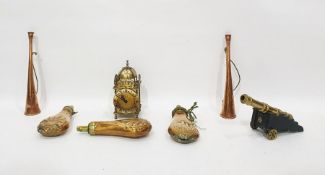 Three brass and copper powder flasks, a miniature brass model of a canon, two copper hunting horns