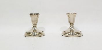 Pair of weighted silver candlesticks