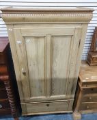 Late 19th/early 20th century pine single door wardrobe with drawer under, raised on turned supports,