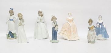 Lladro porcelain figure of a young girl with basket of oranges, four various Nao porcelain figures