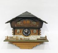 Swiss made three-train cuckoo and musical clock based on an alpine chalet