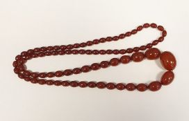 String of red amber-coloured graduated oval beads
