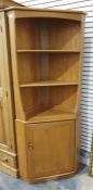Light coloured Ercol corner display cabinet, three shelves above cupboard door