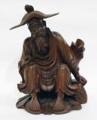 Chinese carved boxwood figure of seated man, with detachable hat, 23cm high