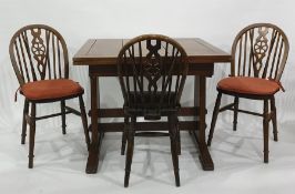 Early 20th century oak two door sideboard, extending rectangular dining table and three wheel back