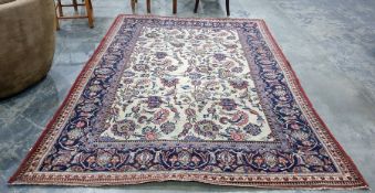 Cream ground Eastern rug, the central field with allover foliate decoration, on a blue ground,