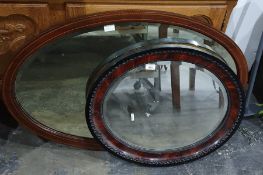 Bevel edged oval mirror with carved wooden frame and another (2)