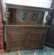 20th century oak reproduction court cupboard with two leaded glazed doors to the upper section above