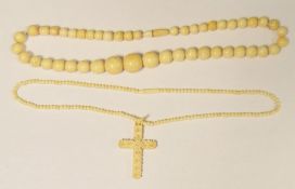 Bone necklace, graduated beads and an ivory-coloured crucifix pendant with necklace