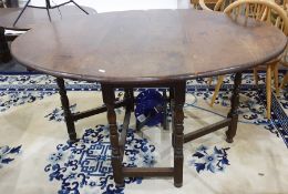 20th century oak oval gateleg dining table on turned and block supports, stretchered base