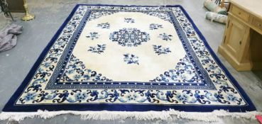Blue and cream large Chinese washed wool rug with central motif of flowers surrounded by other