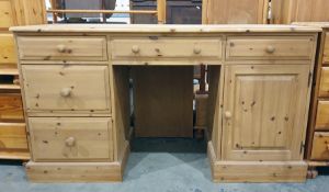 20th century pine dressing table with assorted drawers and cupboard doors, the whole raised upon a