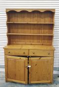 Pine dresser with open shelves above two drawers and two cupboard doors