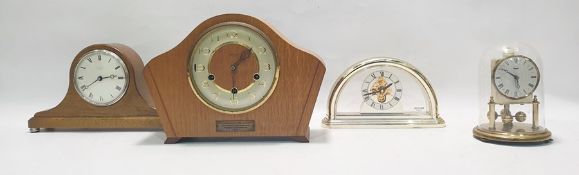 Modern quartz mantel clock with visible movement, a small Kundo anniversary clock and two other