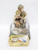 Composition model of a boy and a girl seated overlooking a rectangular-shaped glass fish bowl with