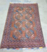 Caucasian-style rug with brown border and two rows of four elephant foot guls surrounded by three