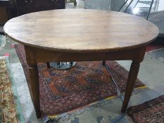 Circular farmhouse-style plank top table raised upon four tapering supports, diameter 135cm approx