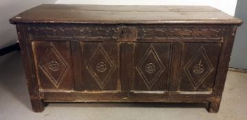 18th century oak coffer, the rectangular top with moulded edge, four front panels with diamond-
