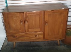 Light elm Ercol sideboard with two cupboard doors above single drawer with full length cupboard door