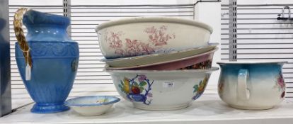 Four assorted ceramic wash basins, a chamber pot, a small dish and a blue and gilt glazed ewer by