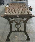 Cast iron garden table with woven lattice style decoration to the top with two cast patterned ends