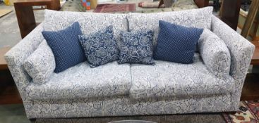 Three-seater sofa with white ground foliate patterned upholstery with scatter cushions  Condition