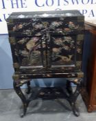 20th century Chinese-style black lacquer and mother-of-pearl decorated cabinet, the pagoda lift