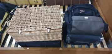 Eastpak backpack, a Samsonite cabin suitcase, a Fila cabin suitcase, a wickerwork picnic basket