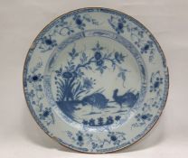 Antique delft-style ceramic plate painted in underglaze blue in the Chinese manner with cockerels