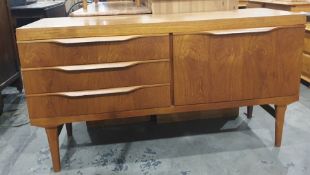 20th century teak sideboard with three drawers to the left and teak fall-door to the right, 134cm