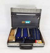 Metal attache case containing college scarves, notebooks, stud box with studs, bow ties, etc