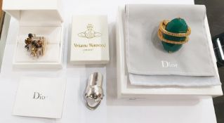 Christian Dior gilt metal costume ring with large green faceted oval stones, held by two bands of
