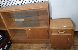 Pair of 20th century oak G-Plan lounge units, each with pair of sliding glass doors enclosing