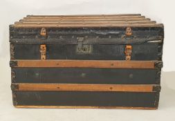 Wooden batoned black leather and studded steamer-type trunk, either end emblazoned with the initials