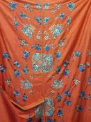Panel of Chinese red ground silk with allover embroidery motifs to include flowers and flying